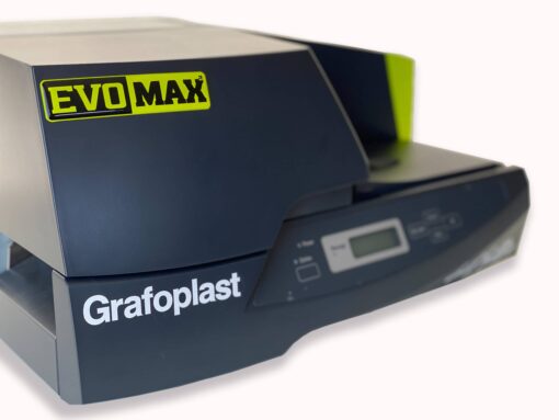 Close-up of a Grafoplast® EVOMAX industrial printer with a digital display and control buttons, showing the brand and model names clearly on the machine’s dark casing.